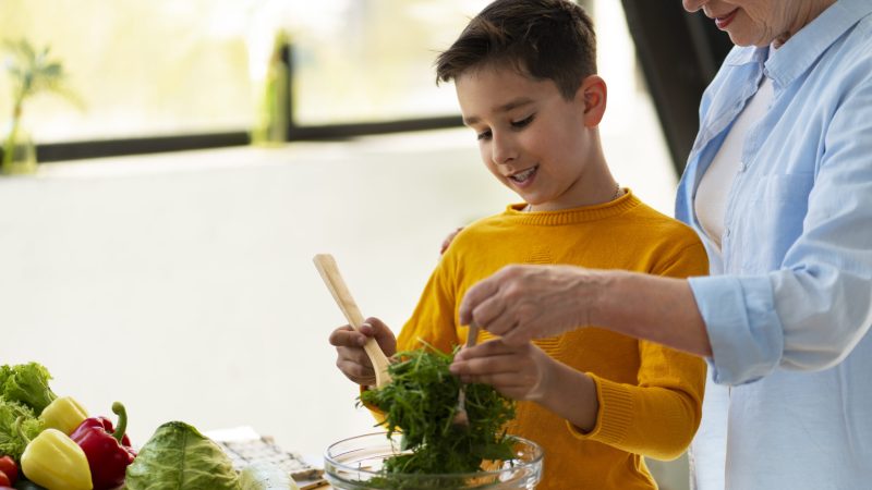 side-view-woman-kid-cooking-together